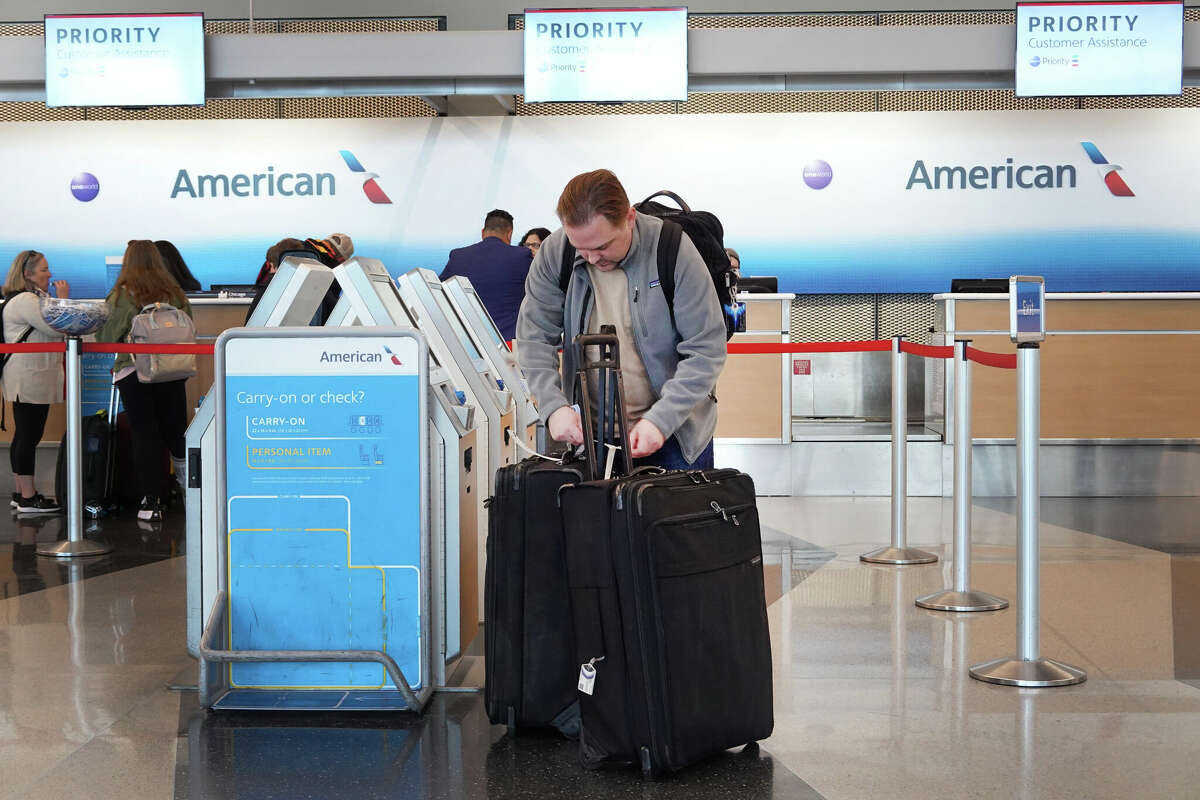 Passengers check in for an American Airlines flightsat O'Hare International Airport on October 11, 2022 in Chicago, Illinois. 