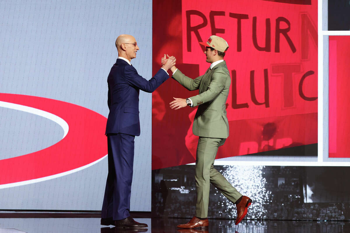 Reed Sheppard (R) shakes hands with NBA commissioner Adam Silver (L) after being drafted third overall by the Houston Rockets during the first round of the 2024 NBA Draft at Barclays Center on June 26, 2024 in the Brooklyn borough of New York City.