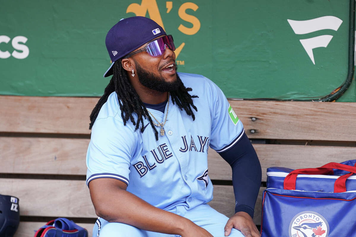 Vladimir Guerrero Jr. #27 of the Toronto Blue Jays looks on in the dugout before the game against the Oakland Athletics at Oakland Coliseum on June 8, 2024 in Oakland, California.