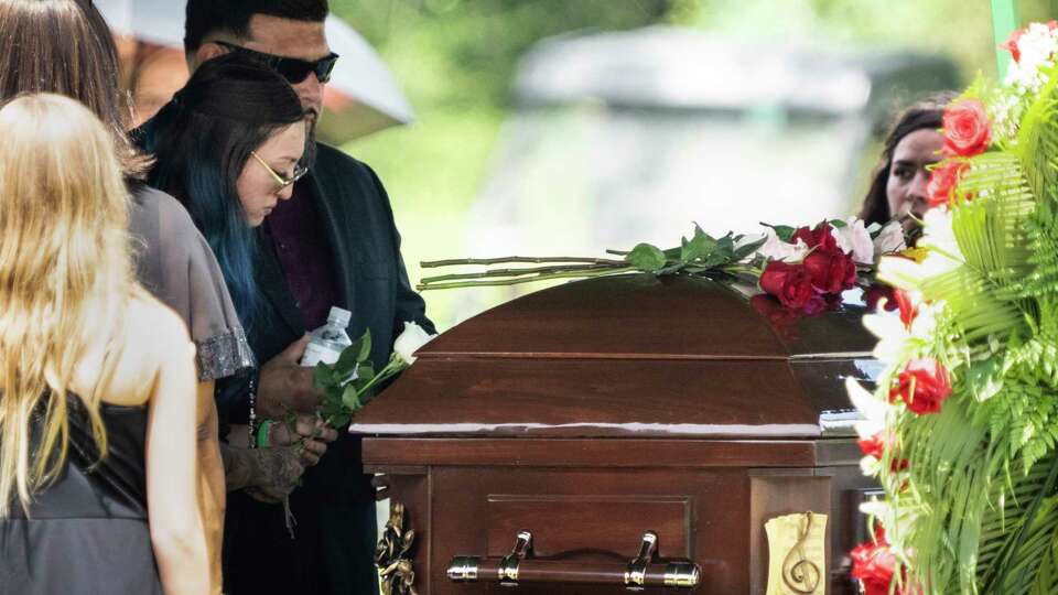 Alexis Nungaray bows her head by the casket of her 12-year-old daughter Jocelyn Nungaray during her graveside service on Thursday, June 27, 2024, in Houston.