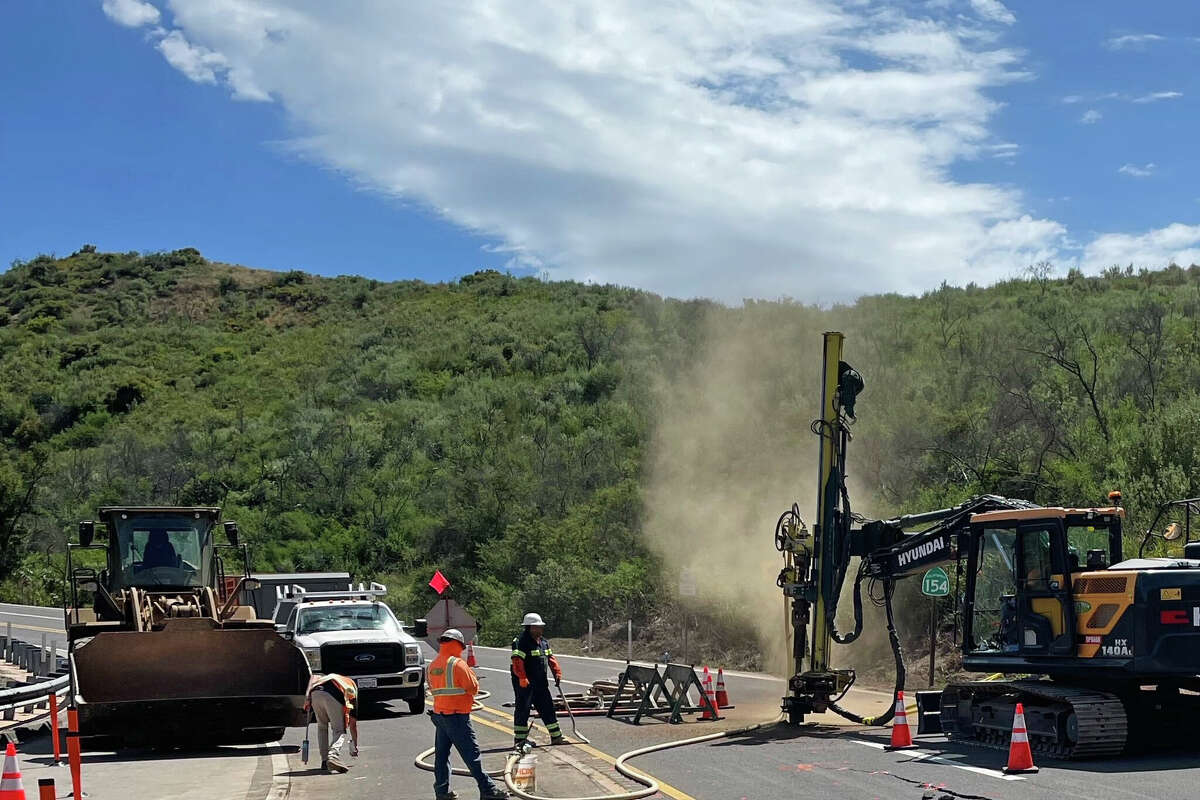 Caltrans workers repair cracks in the road on Highway 154 in Santa Barbara Calif., June 23, 2024.