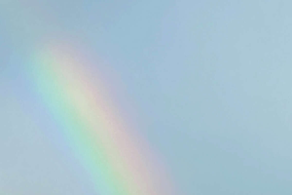 A shrimp boat is seen at the base of a rainbow on Aug. 19, 2022, in Galveston.