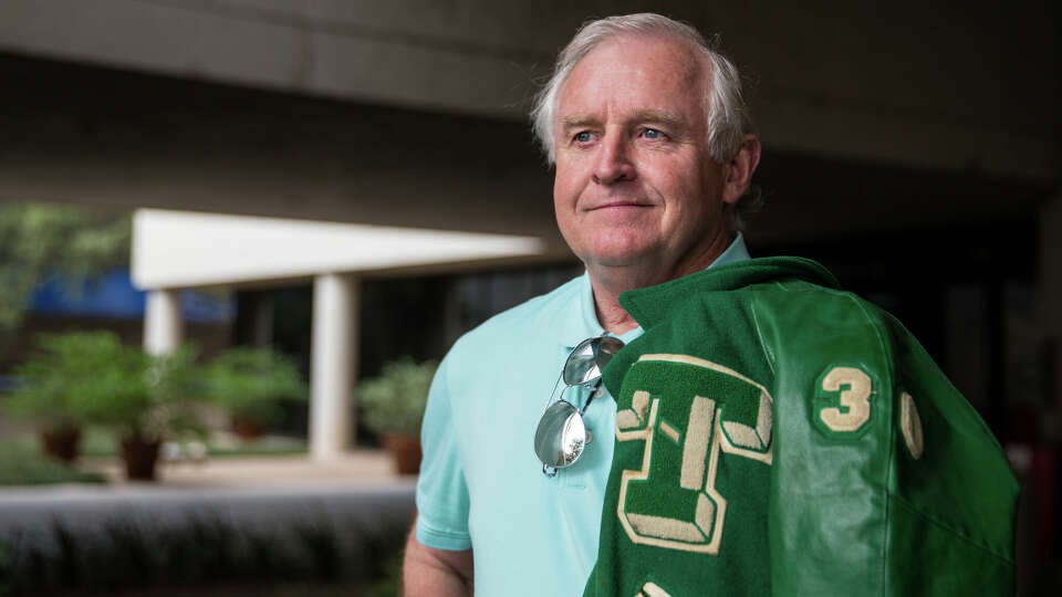 Kirk Bohls, sports columnist at the Austin American-Statesman, wears his number 30 football jacket from Taylor High School on November 7, 2017.