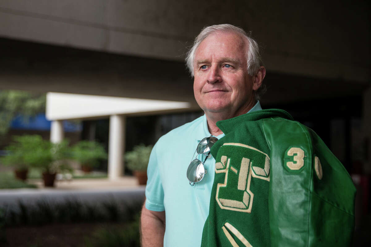 Kirk Bohls, sports columnist at the Austin American-Statesman, wears his number 30 football jacket from Taylor High School on November 7, 2017.