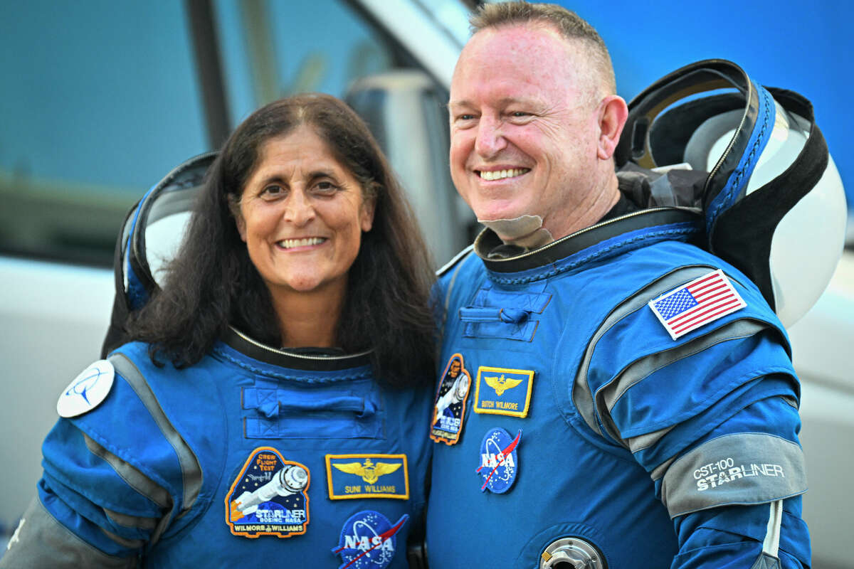 NASA astronauts Butch Wilmore, right, and Suni Williams, wearing Boeing spacesuits, depart the Neil A. Armstrong Operations and Checkout Building at Kennedy Space Center for Launch Complex 41 at Cape Canaveral Space Force Station in Florida to board the Boeing CST-100 Starliner spacecraft for the Crew Flight Test launch , on June 5, 2024. 