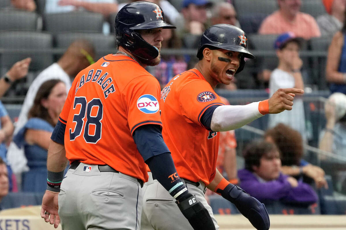 Houston Astros' Trey Cabbage, left, and Jeremy Peña celebrate after both scored on a single hit by Alex Bregman during the eighth inning of a baseball game against the New York Mets, Saturday, June 29, 2024, in New York. (AP Photo/Pamela Smith)