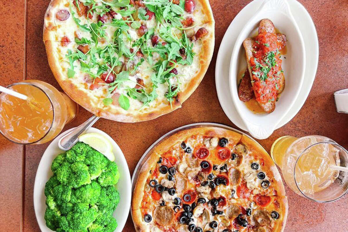 An assortment of dishes, including pizza, from Amici's East Coast Pizzeria.