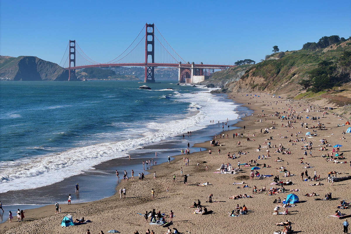 People enjoy at San Francisco's Baker Beach during California's heat wave in California on June 4, 2024. Meteorologists say weather apps can be misleading for temperature forecasts.