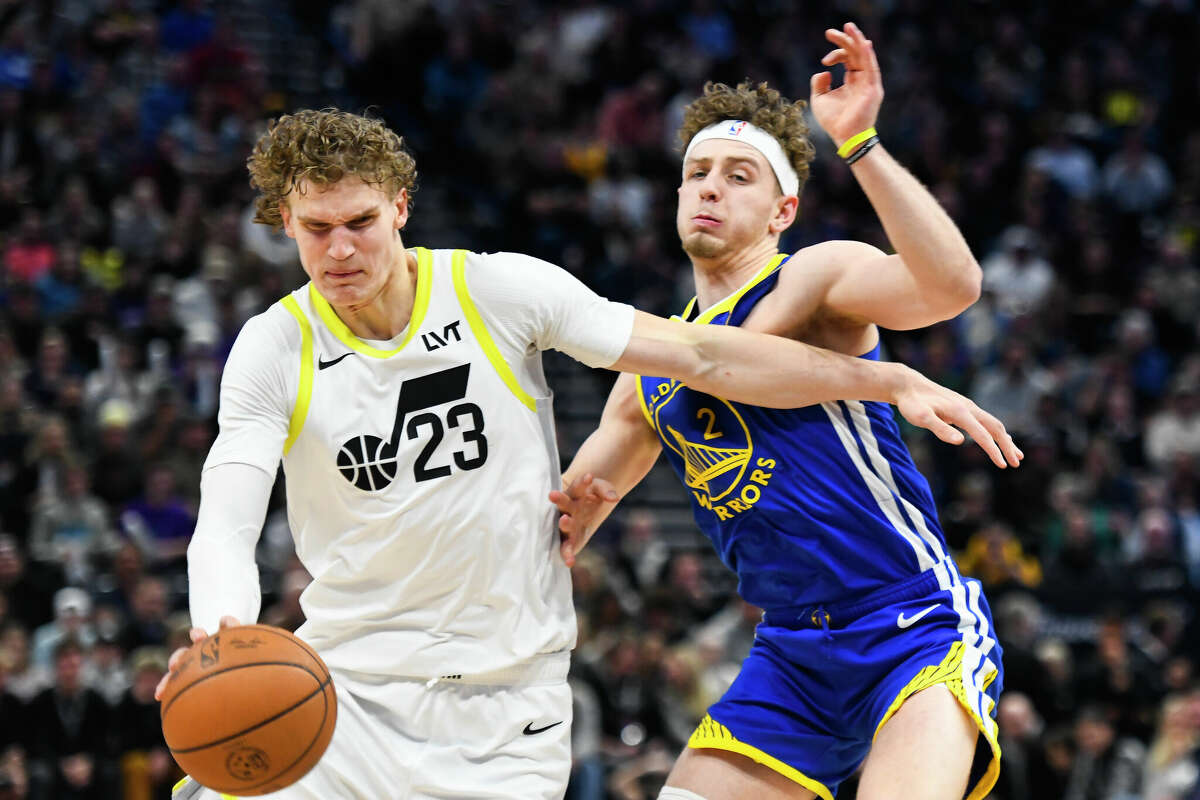 Lauri Markkanen of the Utah Jazz drives into Brandin Podziemski of the Golden State Warriors during the second half of a game at Delta Center on February 15, 2024 in Salt Lake City, Utah.