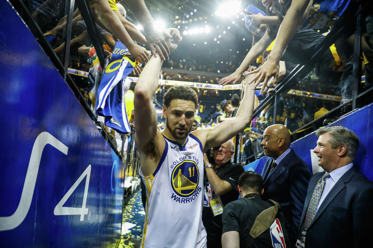 Klay Thompson high-fives fans as he leaves the court after the Golden State Warriors defeated the Houston Rockets in Game 5 of the Western Conference Semifinals at Oracle Arena in Oakland, California, on Wednesday, May 8, 2019. The Golden State Warriors defeated the Houston Rockets 104-99.