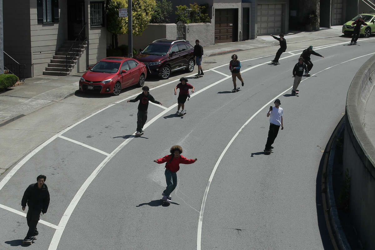 FILE: People ride skateboards down Market Street in San Francisco on Saturday, June 20, 2020, as skateboarders rally over the death of George Floyd. 