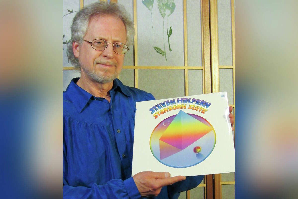 Steven Halpern holding a copy of his album Seduring the recording of 'Starborn Suite.'