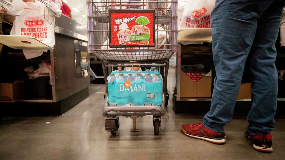 People stock up on water and other groceries in preparation for Tropical Storm Beryl at H-E-B, Saturday, July 6, 2024, in Houston. H-E-B issued limits on water across some Houston locations.