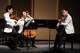Violinist Angelo Xiang Yu, left, cellist Efe Baltacigil and violist Matthew Lipman perform Françaix’s String Trio at Music@Menlo Festival.