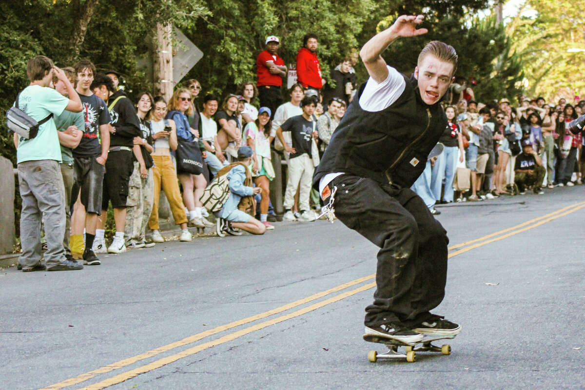 Cash Humphries bombs down Church Street on Saturday, July 6, 2024, in San Francisco. After police shut down Dolores Street, skateboarders gathered one block away for an evening of high-stakes riding.