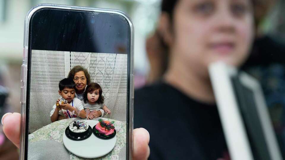 Haley Loredo holds a cell phone photo of her children with their grandmother, Maria Loredo, 73, who died after a tree fell on her second story bedroom at their home in the 17400 block of Rustic Canyon Trail during Hurricane Beryl Monday, July 8, 2024, in Spring. The cell phone photo was taken Feb. 10, 2024.