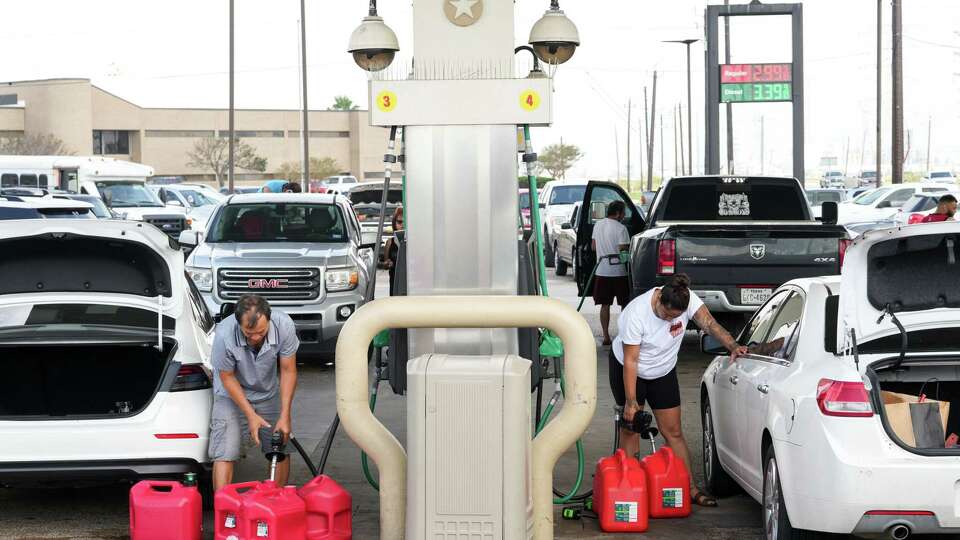 People fill gas cans the day after Hurricane Beryl made landfall nearby Tuesday, July 9, 2024, in Freeport.