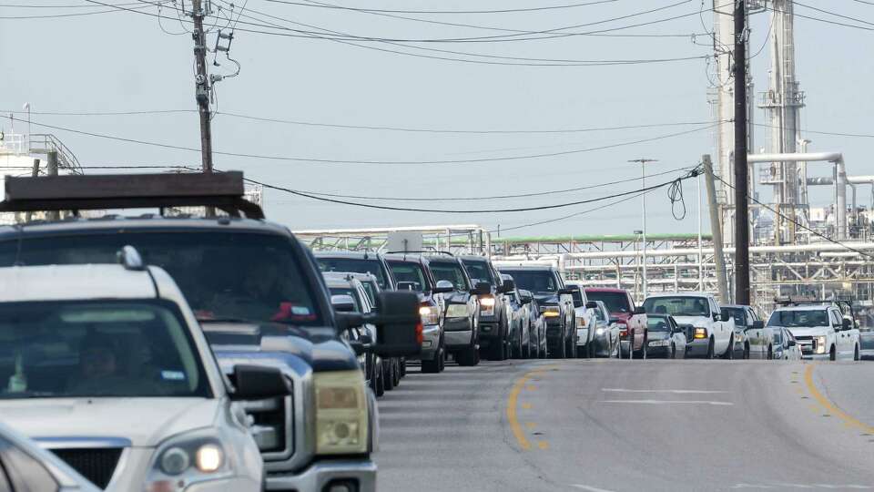 People wait in line for gas the day after Hurricane Beryl made landfall nearby Tuesday, July 9, 2024, in Freeport.