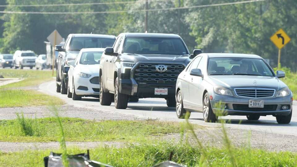 Vehicles line up gas at a gas station along Ford Road near Loop 494 after Hurricane Beryl made its way through the Greater Houston area on Monday as a Category 1 storm, Tuesday, July 9, 2024, in Houston.