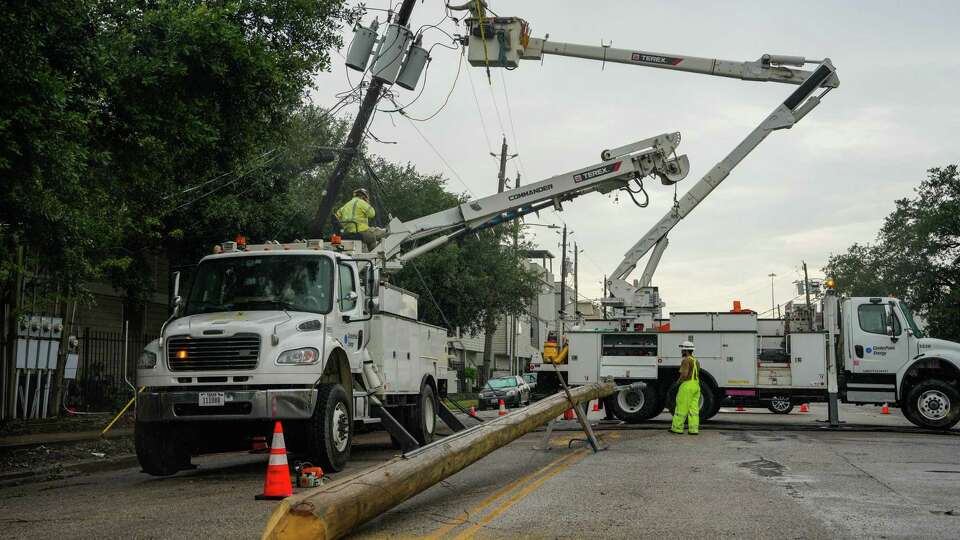 Linemen tend to fallen power lines in the East End neighborhood of Houston, days after Hurricane Beryl made landfall, on Thursday, July 11, 2024 in Houston.