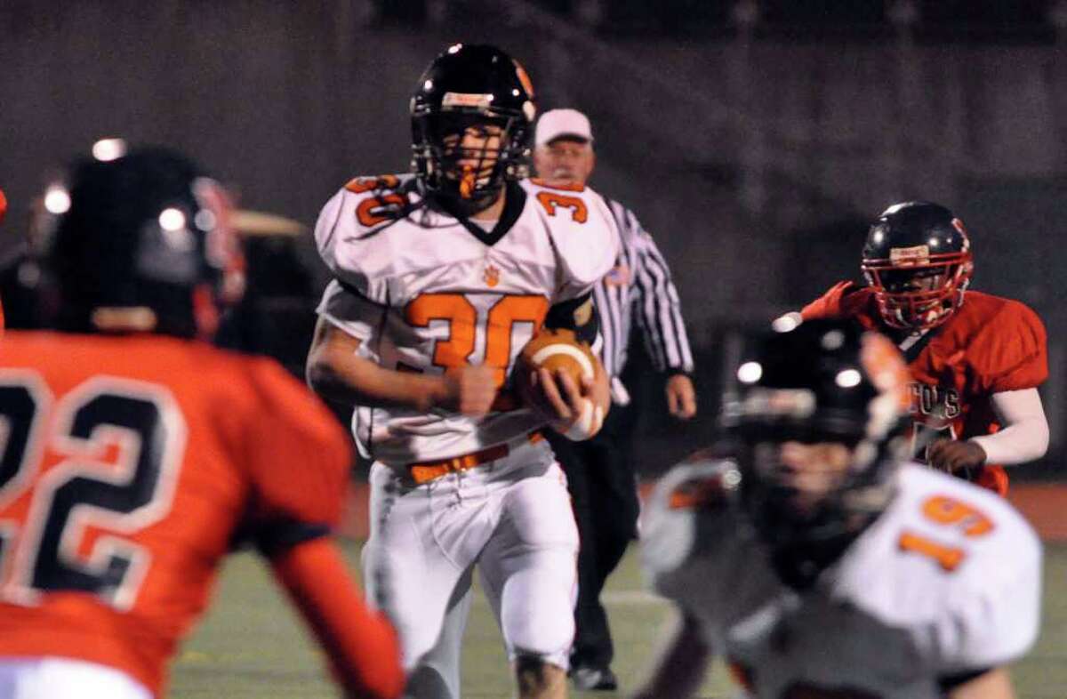 Ridgefield's Sam Gravitte carries the ball during the varsity football game against Brien McMahon at McMahon on Friday, Oct. 29, 2010.
