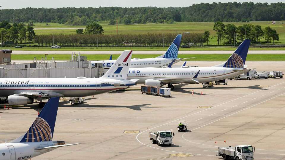 A variety of United Airlines aircraft, including a Airbus A320 painted in a livery from 1972-74, are parked at the gates at George Bush Intercontinental Airport on Tuesday, July 16, 2024 in Houston.