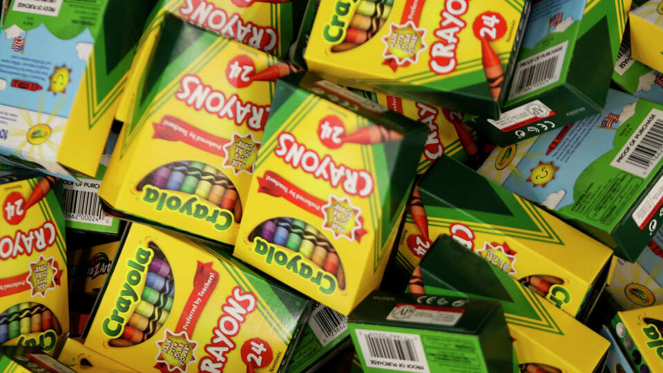 Crayons are seen as volunteers pack more than 1,500 backpacks with school supplies at Bradley Elementary School, Saturday, Aug. 5, 2023, in Spring. The annual effort helps provide supplies to students in 13 Conroe ISD schools.