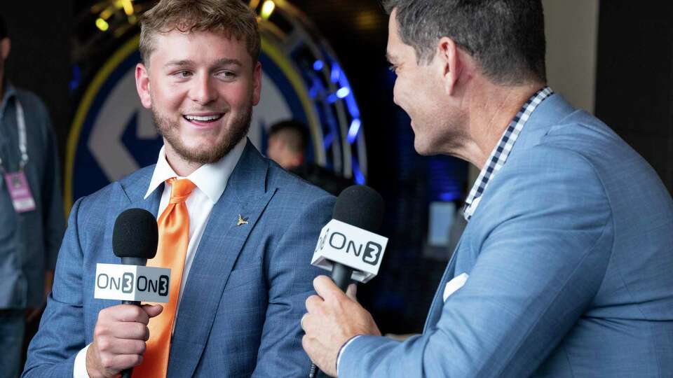 Texas quarterback Quinn Ewers, left, talks to radio host Andy Staples during the Southeastern Conference NCAA college football media days Wednesday, July 17, 2024, in Dallas. (AP Photo/Jeffrey McWhorter)