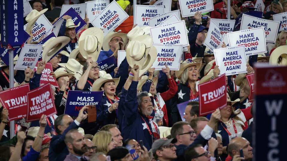 MILWAUKEE, WISCONSIN - JULY 17: Members of the Texas delegation hold signs that read 'Make America Strong Again' on the third day of the Republican National Convention at the Fiserv Forum on July 17, 2024 in Milwaukee, Wisconsin. Delegates, politicians, and the Republican faithful are in Milwaukee for the annual convention, concluding with former President Donald Trump accepting his party's presidential nomination. The RNC takes place from July 15-18.