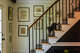 Christine Adams' cat on the stairs of her antique home in New Preston, photographed July 3, 2024.