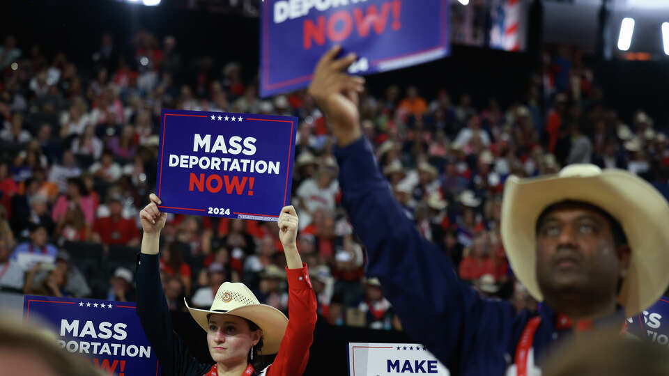 MILWAUKEE, WISCONSIN - JULY 17: A person holds a sign that reads 'Mass Deportation Now' on the third day of the Republican National Convention at the Fiserv Forum on July 17, 2024 in Milwaukee, Wisconsin. Delegates, politicians, and the Republican faithful are in Milwaukee for the annual convention, concluding with former President Donald Trump accepting his party's presidential nomination. The RNC takes place from July 15-18. (Photo by Joe Raedle/Getty Images)