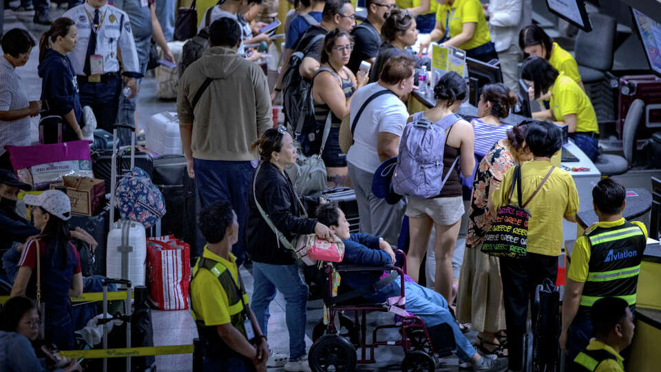 Long lines of passengers form at the check-in counters at Ninoy Aquino International Airport, amid a global IT disruption caused by a Microsoft outage and a Crowdstrike IT problem, on July 19, 2024 in Manila, Philippines. A significant Microsoft outage impacted users globally, leading to widespread disruptions, including cancelled flights and disruptions at retailers globally. Airlines like American Airlines and Southwest Airlines reported difficulties with their systems, which rely on Microsoft services for operations. The outage affected check-in processes and other essential functions, causing frustration among travellers and lines to back up at many affected airports worldwide. (Photo by Ezra Acayan/Getty Images)