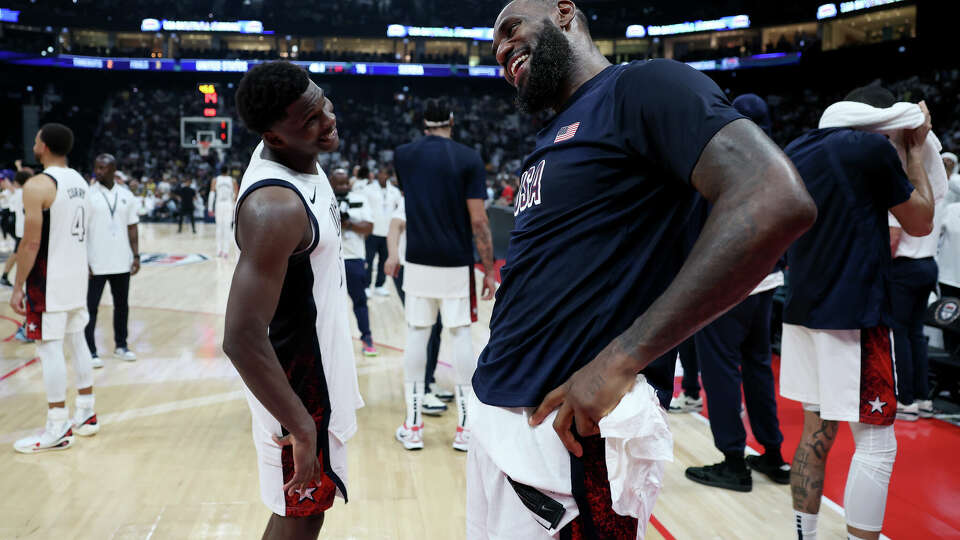 Anthony Edwards is the youngest member of the U.S. men's basketball team. He celebrates in recent exhibitin game against Serbia with LeBron James, the oldest. 