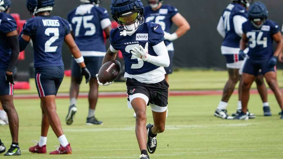 Houston Texans wide receiver Tank Dell (3) runs up the field after a catch during an NFL training camp Friday, July 19, 2024, in Houston.