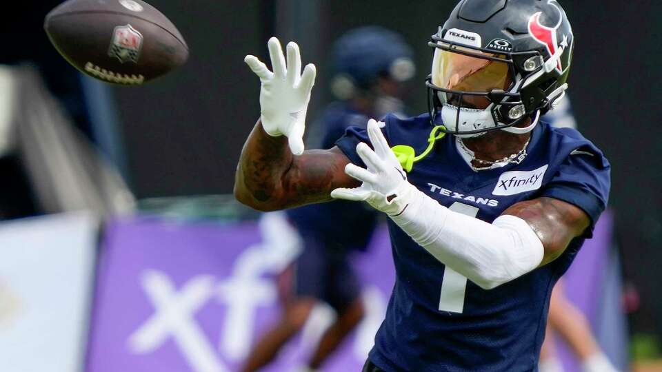 Houston Texans wide receiver Stefon Diggs reaches back to make a catch during an NFL training camp Friday, July 19, 2024, in Houston.