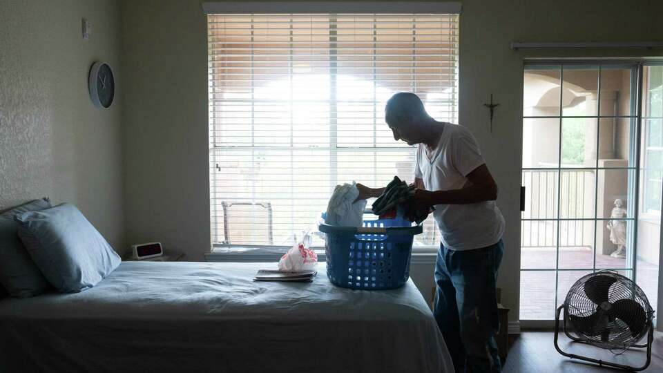 Mike Mancuso, 84, unpacks in his independent living apartment at The Terraces at Kingwood Town Center on Wednesday morning July 17, 2024 minutes after moving back in after power was finally restored following Hurricane Beryl. He went to stay with his stepson after the Kingwood, TX senior complex lost power for 9 days.