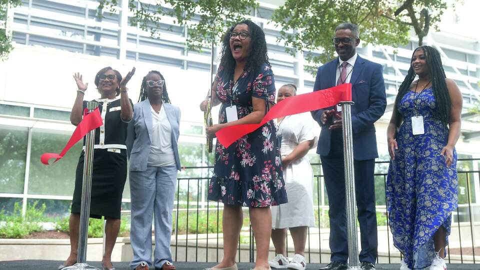 Heather Vaughan-Batten, granddaughter of Dorothy Vaughan, reacts after cutting a ribbon during the dedication ceremony for the renaming of Building 12 at Johnson Space Center to Dorothy Vaughan Center in Honor of Women of Apollo on Friday, July 19, 2024 in Houston.