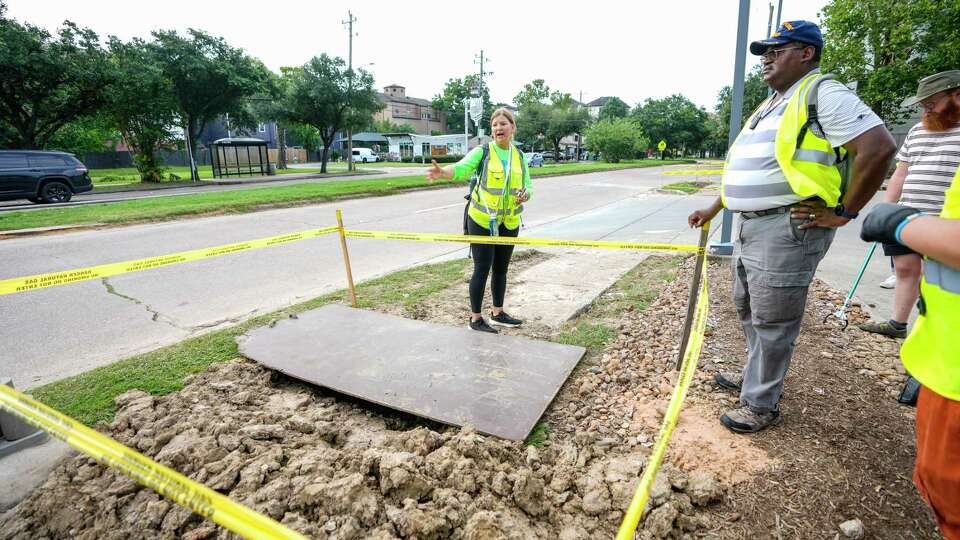 Laura Conely, of Urban Paths, left, talks with Dexter Handy, chairman of the Citizens’ Transportation Coalition about the condition of the sidewalk during a Montrose Boulevard audit/walk with residents and activists who are pro boulevard renovation on Montrose Boulevard on Saturday, July 20, 2024, in Houston.