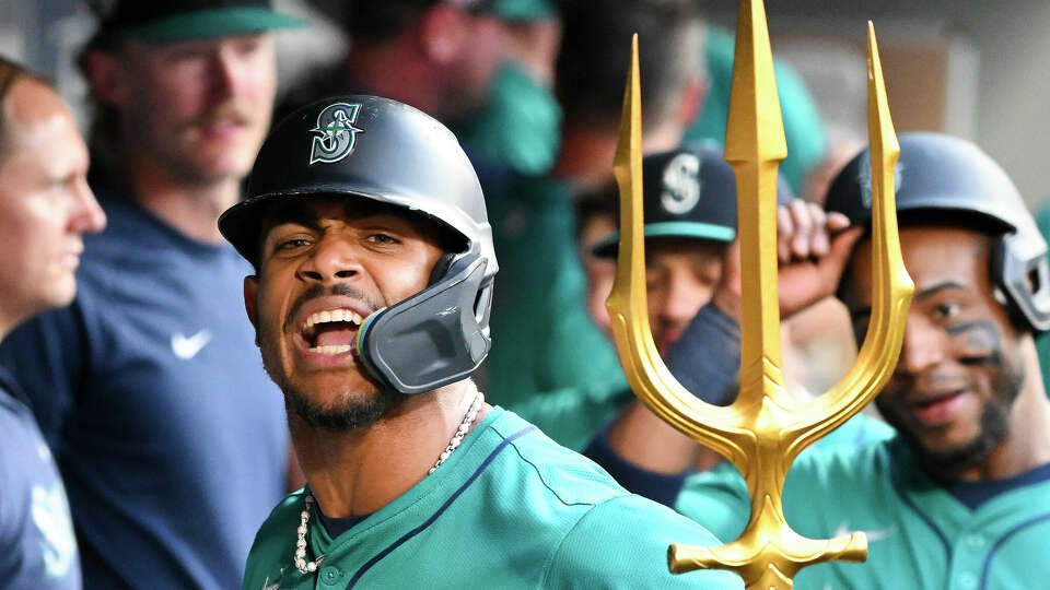 SEATTLE, WASHINGTON - JULY 20: Julio Rodriguez #44 of the Seattle Mariners celebrates with teammates after hitting a two-run home run during the sixth inning against the Houston Astros at T-Mobile Park on July 20, 2024 in Seattle, Washington. (Photo by Alika Jenner/Getty Images)