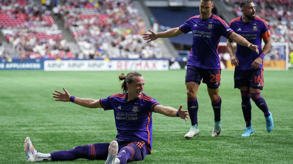 Houston Dynamo's Griffin Dorsey, from left to right, Erik Sviatchenko and Hector Herrera celebrate Dorsey's goal against the Vancouver Whitecaps during the first half of an MLS soccer match in Vancouver, British Columbia, Saturday, July 20, 2024. (Darryl Dyck/The Canadian Press via AP)