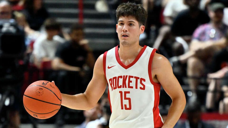 Houston Rockets guard Reed Sheppard (15) handles the ball against the Los Angeles Lakers during the second half of an NBA summer league basketball game Friday, July 12, 2024, in Las Vegas. (AP Photo/David Becker)