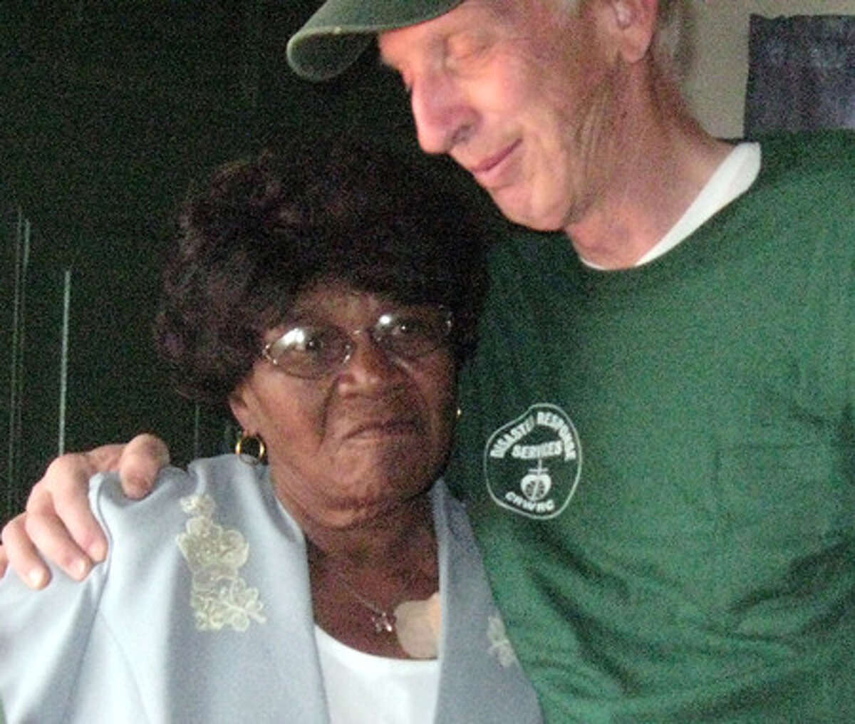Elizabeth Thigpen, 78, gets a hug Friday from Leroy Koppendrayer, a Minnesota volunteer who helped rebuild her hurricane-damaged home. Dee Dixon/The Enterprise
