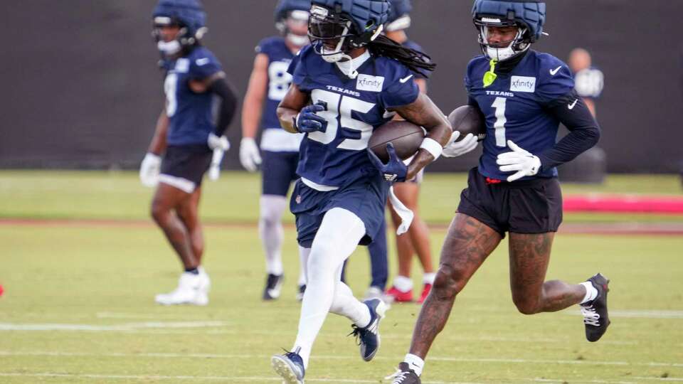 Houston Texans wide receivers Noah Brown (85) and Stefon Diggs (1) run with the ball after making catches during an NFL training camp Monday, July 22, 2024, in Houston.