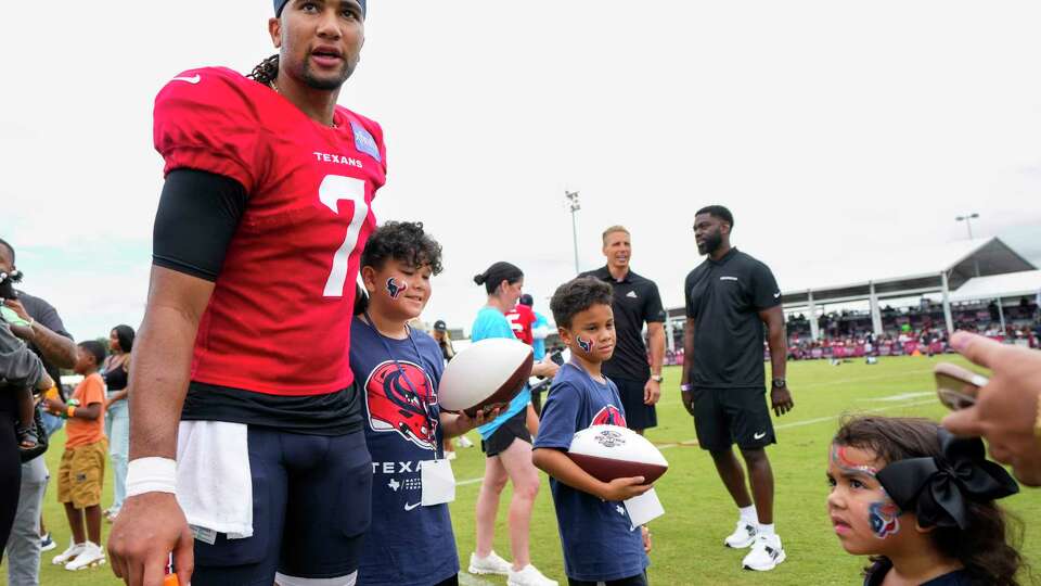 Houston Texans quarterback C.J. Stroud (7) interacts with a group of young fans after practice during an NFL training camp Tuesday, July 23, 2024, in Houston.