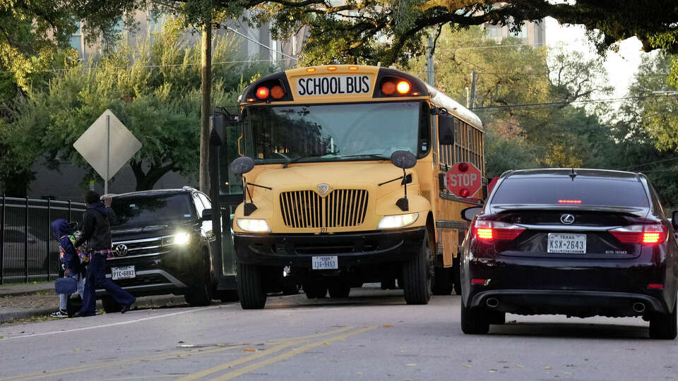 A school bus dropping off students on La Branch Street Wednesday, Nov. 30, 2022, at MacGregor Elementary in Houston.