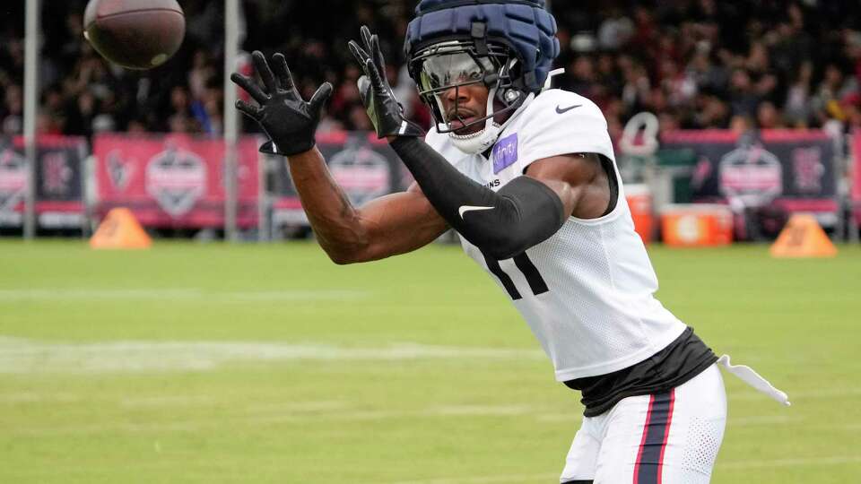 Houston Texans cornerback Jeff Okudah reaches out to catch a ball during an NFL training camp Wednesday, July 24, 2024, in Houston.