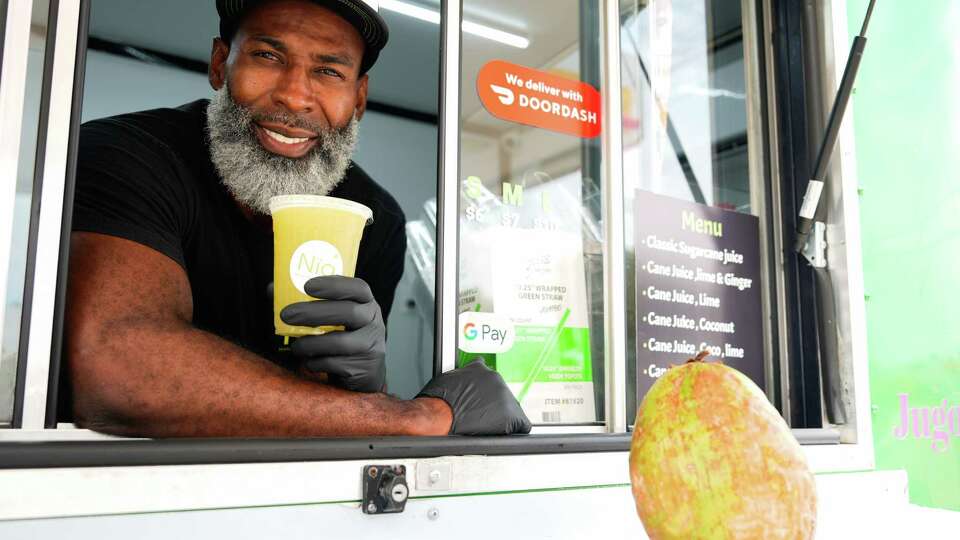 Sharon Coleman is seen the window of his drink truck business, Nia Cane, Wednesday, July 24, 2024, in Sugar Land. Coleman sells fresh, Alabama sugar cane juice and coconut juice from the truck in front of a Shell gas station off of South Texas 6 and Voss Road, one of four locations the Alabama native has around the Greater Houston area.