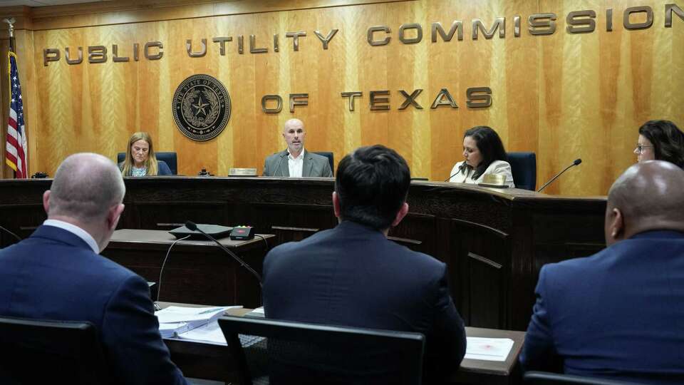 Public Utility Commission of Texas Commissioners Courtney Hjaltman, from rear left, Chairman Thomas Gleeson, Lori Cobos and Kathleen Jackson speak to a leadership team from CenterPoint Energy about Hurricane Beryl during a PUC meeting Thursday, July 25, 2024, in the Commissioners Hearing Room at the William B. Travis State Office Building in Austin.