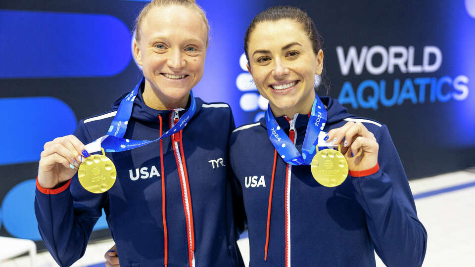 BERLIN, GERMANY - MARCH 24: Sarah Bacon and Kassidy Cook of Team USA pose with gold medal after the Women's Synchronized 3m Springboard Final during the World Aquatics Diving World Cup 2024 - Stop 2 on March 24, 2024 in Berlin, Germany. (Photo by Maja Hitij/Getty Images)