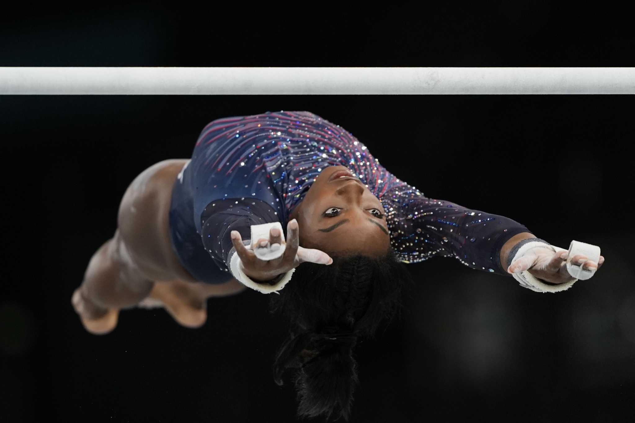 Simone Biles submits an original skill on uneven bars ahead of Paris